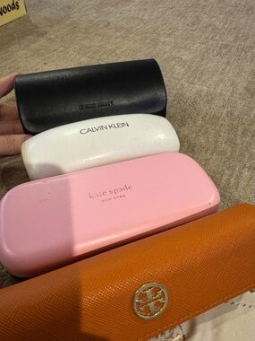 4 sunglasses cases. Kate spade, Tori Burch, Calvin Klein and Giorgi Armani